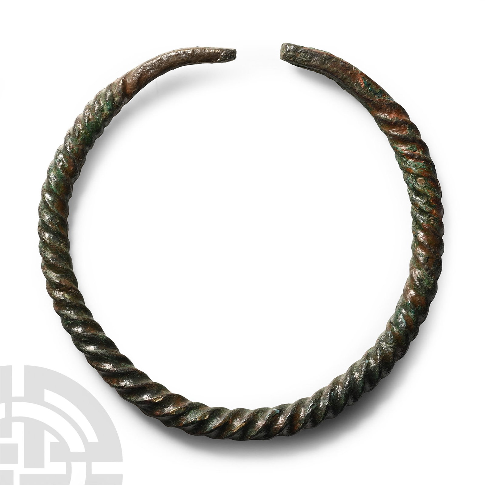 Twisted Bronze Bracelet: 1st millennium B.C. Comprising a round-section twisted shank and tapering flat-section finials. 21.8 grams, 60 mm (2 3/8 in.). [No Reserve] UK private collection before 2000. Acquired on the UK art ma