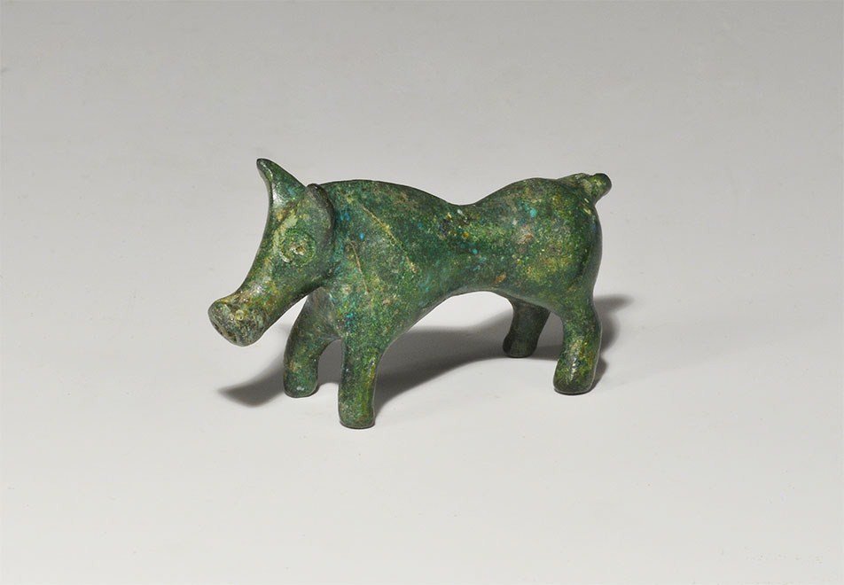 Iron Age Celtic Boar Figurine: 2nd century BC-1st century AD. A cast bronze figure of a standing boar with looped tail, carefully modelled ears and snout. 49 grams, 54 mm (2 1/4"). Private collection, Buckinghamshire, UK; formed in