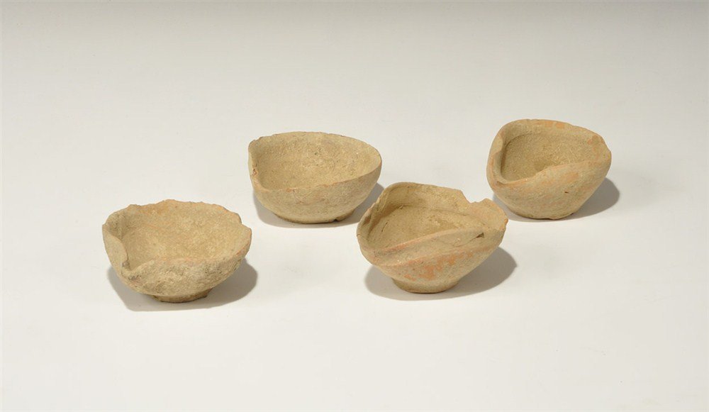Bronze Age Ceramic Oil Lamp Group: 1st millennium BC. A group of four ceramic oil lamps, each with discoid base and broad bowl with pinched spout. 277 grams total, 71-80 mm (2 3/4 - 3 1/4"). From an old Essex collection. [4, No Reserve