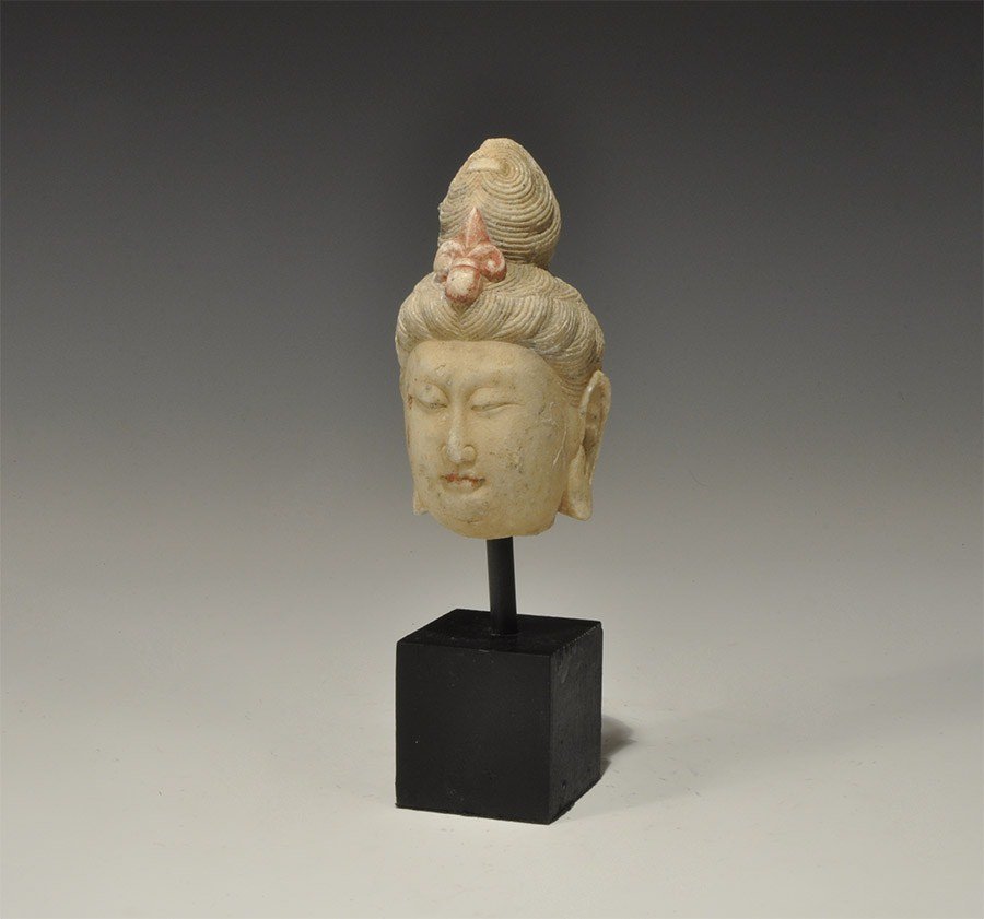 Chinese Style Stone Buddha Head: An undated archaistic carved stone head of the Buddha with elaborately dressed hair and trefoil motif to the brow; supplied with a custom-made display stand. 672 grams, 20 cm including stand. (8"). Pr