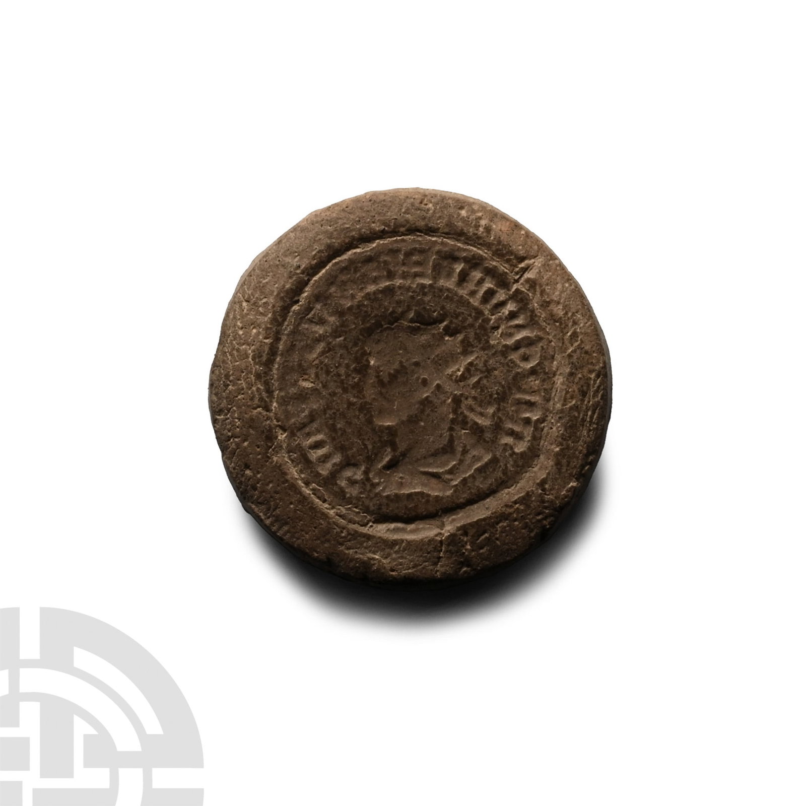 Roman Bifacial Terracotta Forger's Coin Mould: 3rd century A.D. Discoid in plan, one side with profile bust of an emperor wearing a radiate crown, legend surrounding; the reverse with two facing figures on a baseline. 3.4 grams, 26 mm (1 in.). [No
