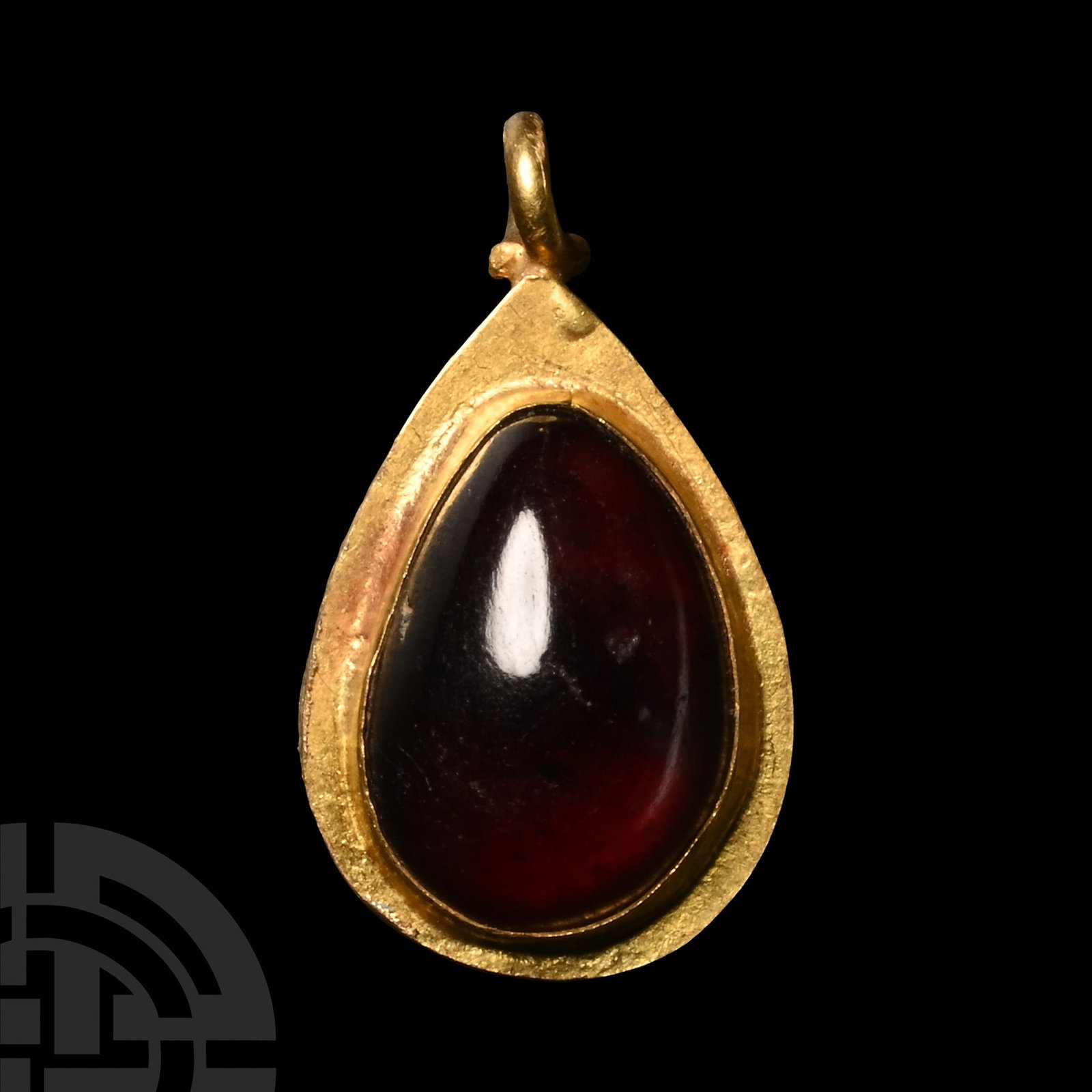 Roman Gold and Garnet Pendant: 1st-4th century A.D. Gold teardrop pendant with inset cabochon garnet in stepped cell, loop above. 1.20 grams, 15 mm (5/8 in.). Ex property of a late Japanese collector, 1970-2000s.