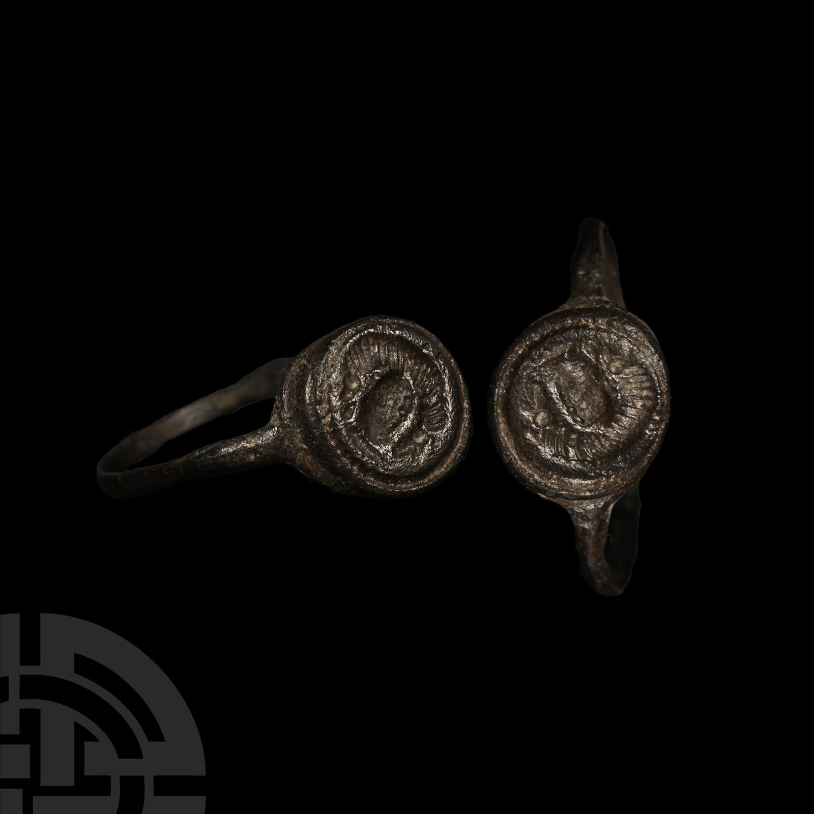 Roman Bronze Ring with Wolf: 1st century A.D. With slender hoop, discoid bezel with incuse image of the she-wolf suckling Romulus and Remus. Cf. Ruseva-Slokoska, L., Roman Jewellery, Sofia, 1991, item 233, for type. 3.40 grams, 2