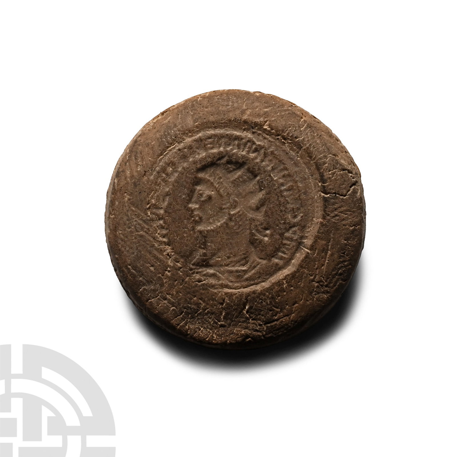 Roman Bifacial Terracotta Forger's Coin Mould: 3rd century A.D. Discoid in plan, one side with profile bust of an emperor wearing a radiate crown, legend surrounding; the reverse with a standing female figure holding wreath towards emperor. 4.43 g