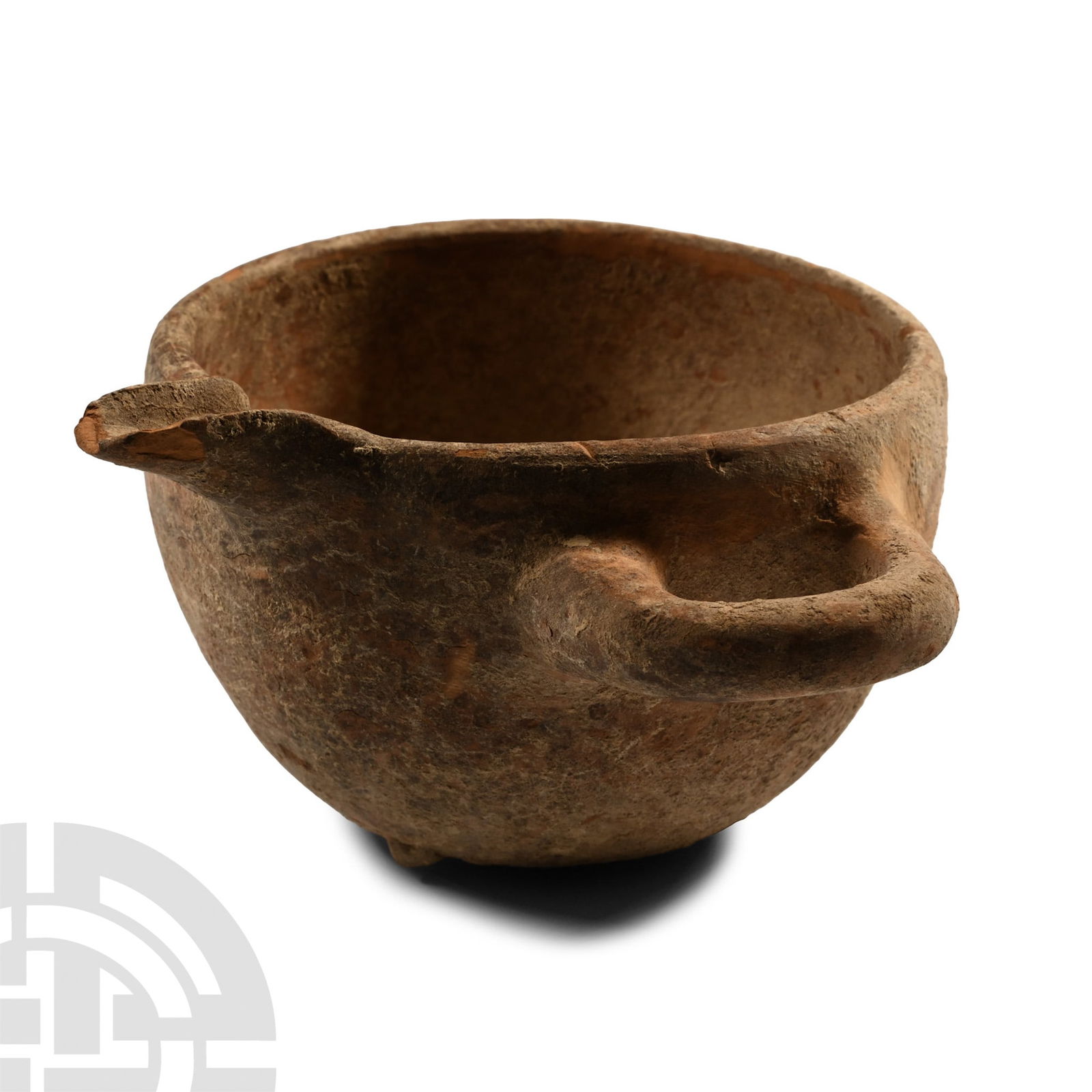 Luristan Terracotta Spouted Cup: Circa 800-600 B.C. With a short pouring spout on the rim and a single horizontal lateral handle; three stub feet to the base. 232 grams, 13 cm (5 1/8 in.). [No Reserve] Acquired 1980-2015. Ex Abelita