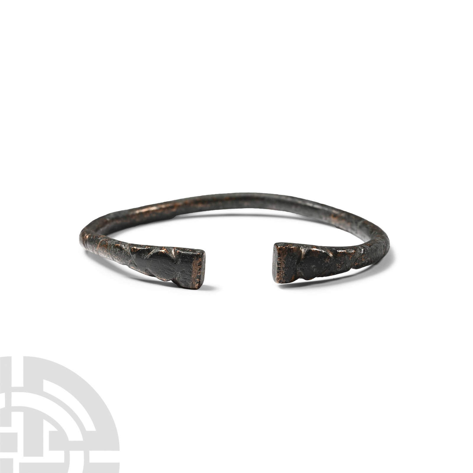 Bronze Bracelet: 1st millennium B.C. Comprising a round-section penannular body and stylised beast-head finials. 18.2 grams, 62 mm (2 3/8 in.). [No Reserve] Ex German art market, 2000s. Acquired from an EU collector l