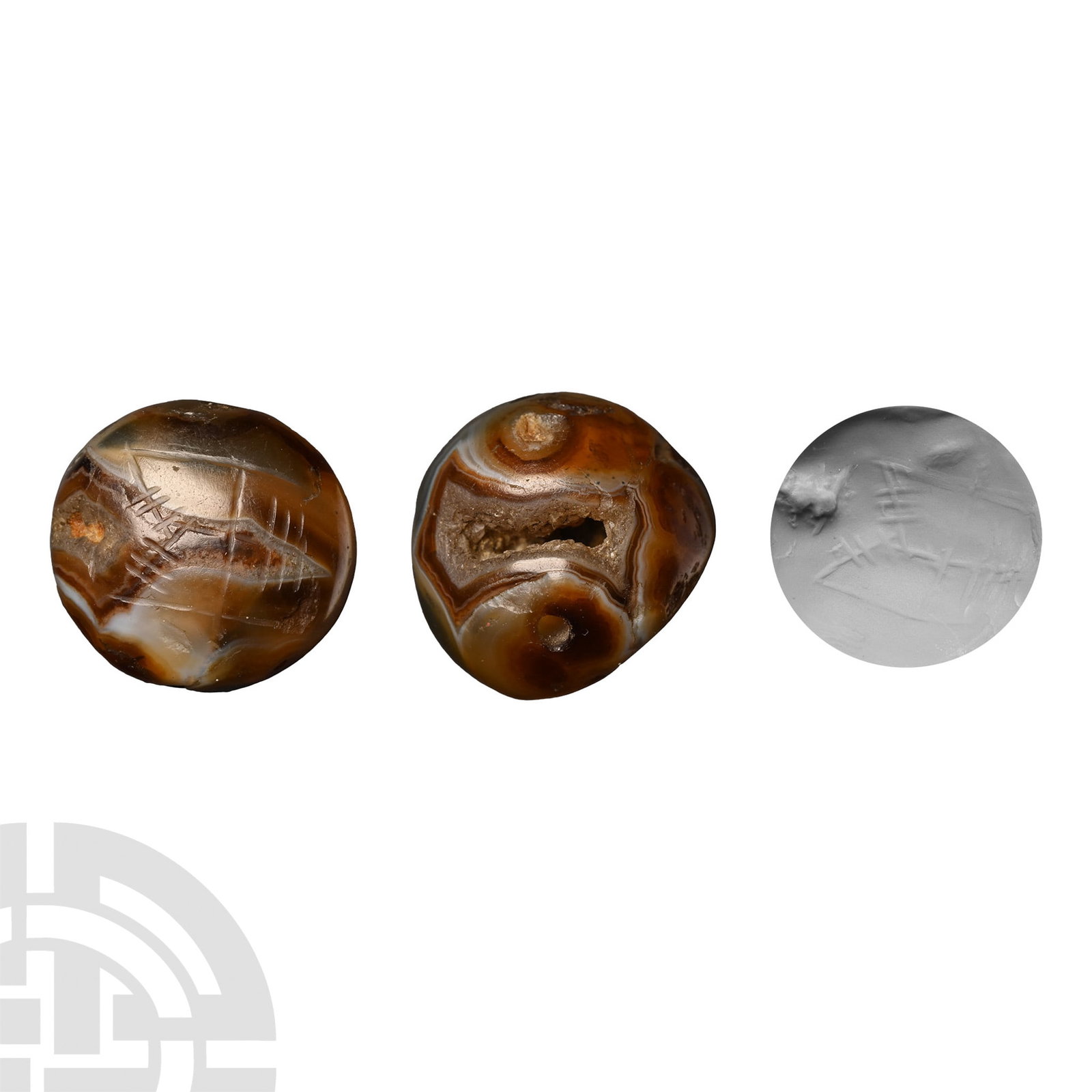 Sasanian Banded Agate Stamp Seal: 3rd-7th century A.D. Comprising a domed body carved from banded agate and having a natural crystal-lined cavity to one side, drilled through the base, underside with engraved linear motif, possibly an
