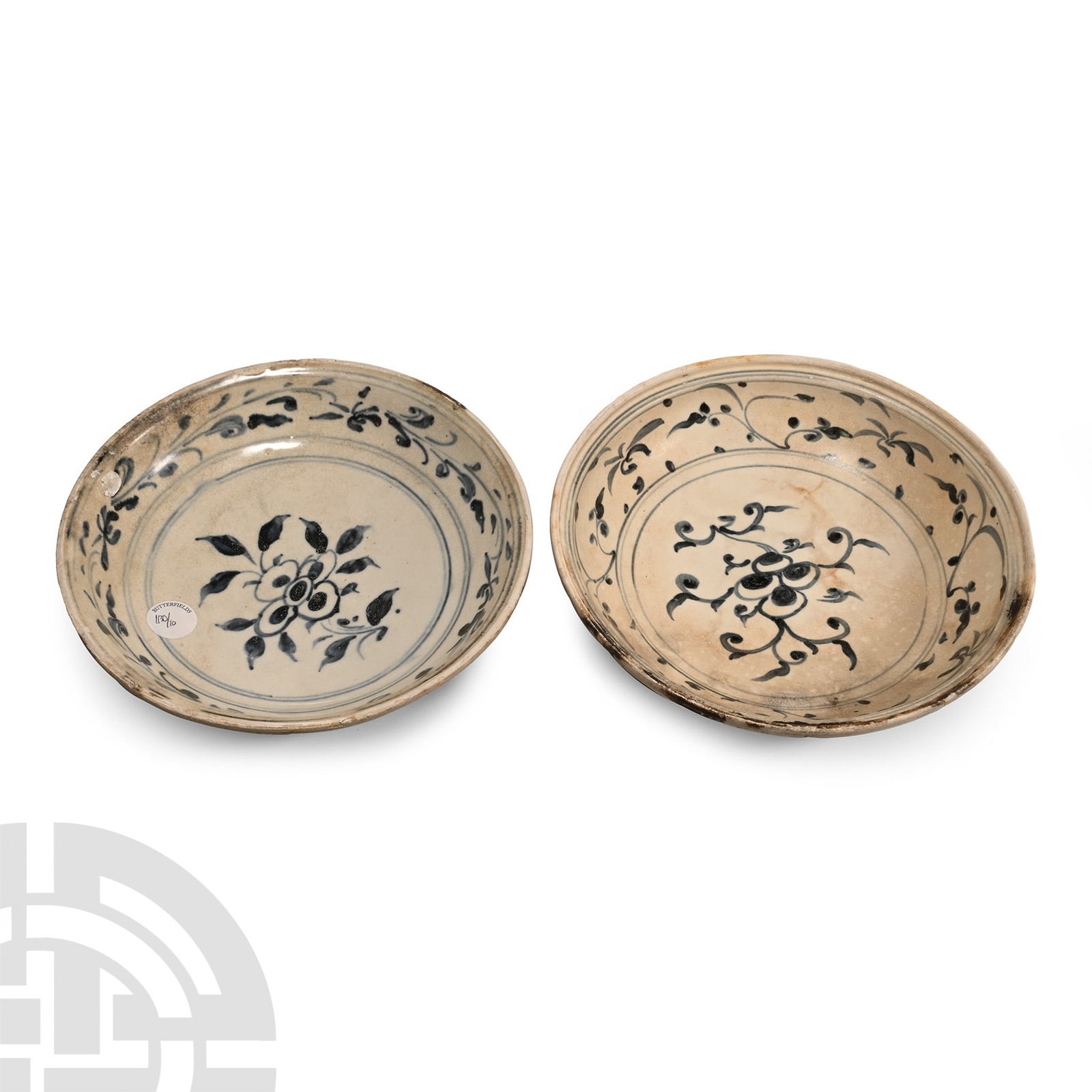 Large Hoi An Cargo Shipwreck Glazed Plate Pair: 15th century A.D. Comprising two shallow plates with gently sloping walls, painted central flower motif within and foliate border, radiating petals to the outer face. 1.78 kg total, 24-24.2 cm (9 1/2 
