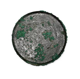 Greek Bronze Mirror with Floral Pattern: Circa 6th century B.C. Discoid with raised beaded rim, obverse slightly convex with a guilloche border; the reverse with a central five-petalled flower and three pairs of concentric circles, crescenti