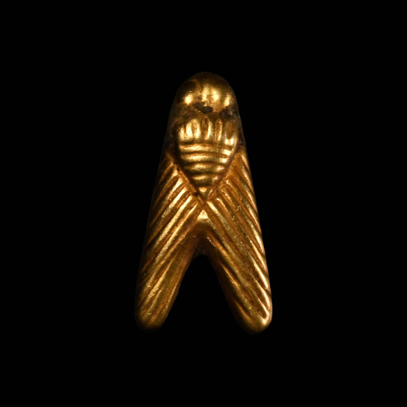 Egyptian Gold Fly Amulet: Late Period, 664-332 B.C. With hatched detailing to the body and wings. See Andrews, C., Amulets of Ancient Egypt, London, 1994, fig. 48, for similar examples of gold flies. 1.62 grams, 17 mm (5/8 in.