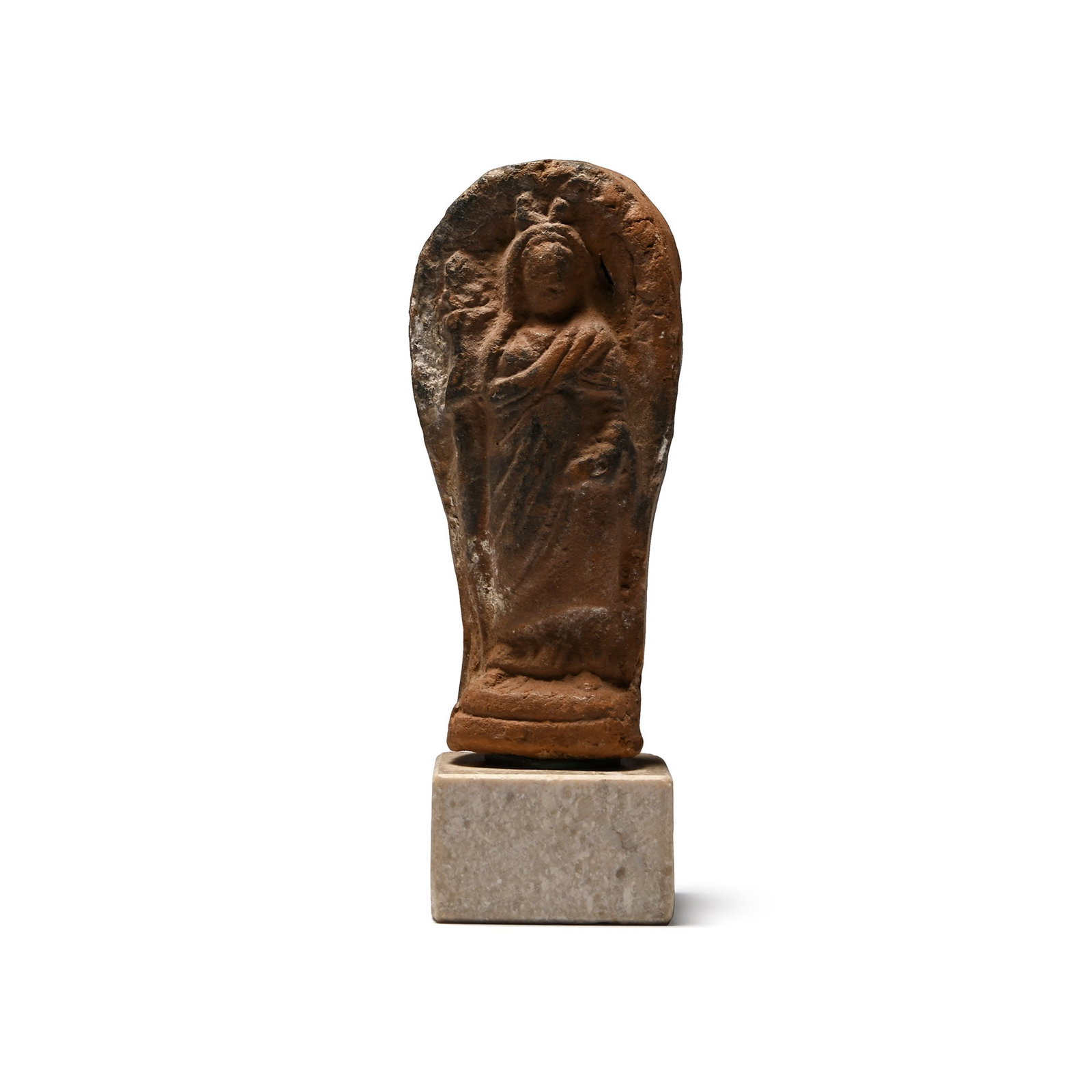 Roman Terracotta Figure of Isis: 1st-2nd century A.D. Hollow-formed piriform moulded figurine with standing female modelled in the half-round wearing a draped stola covering her head and gathered in her left hand, tiered base and dec