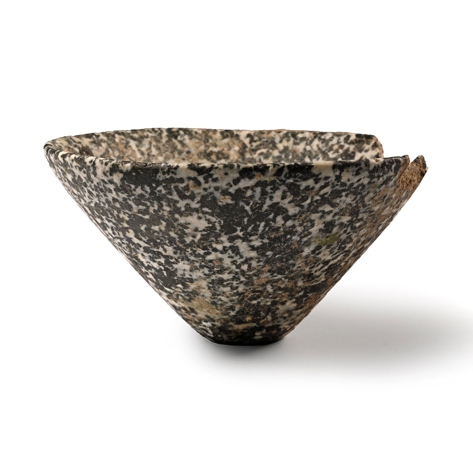 Mesopotamian Granite Bowl: 3rd millennium B.C. Conical in profile with narrow base and rounded rim; diorite; rim chipped. 184 grams, 10 cm (4 in.). (For this specific lot, 5% import VAT is applicable on the hammer price.) Priva