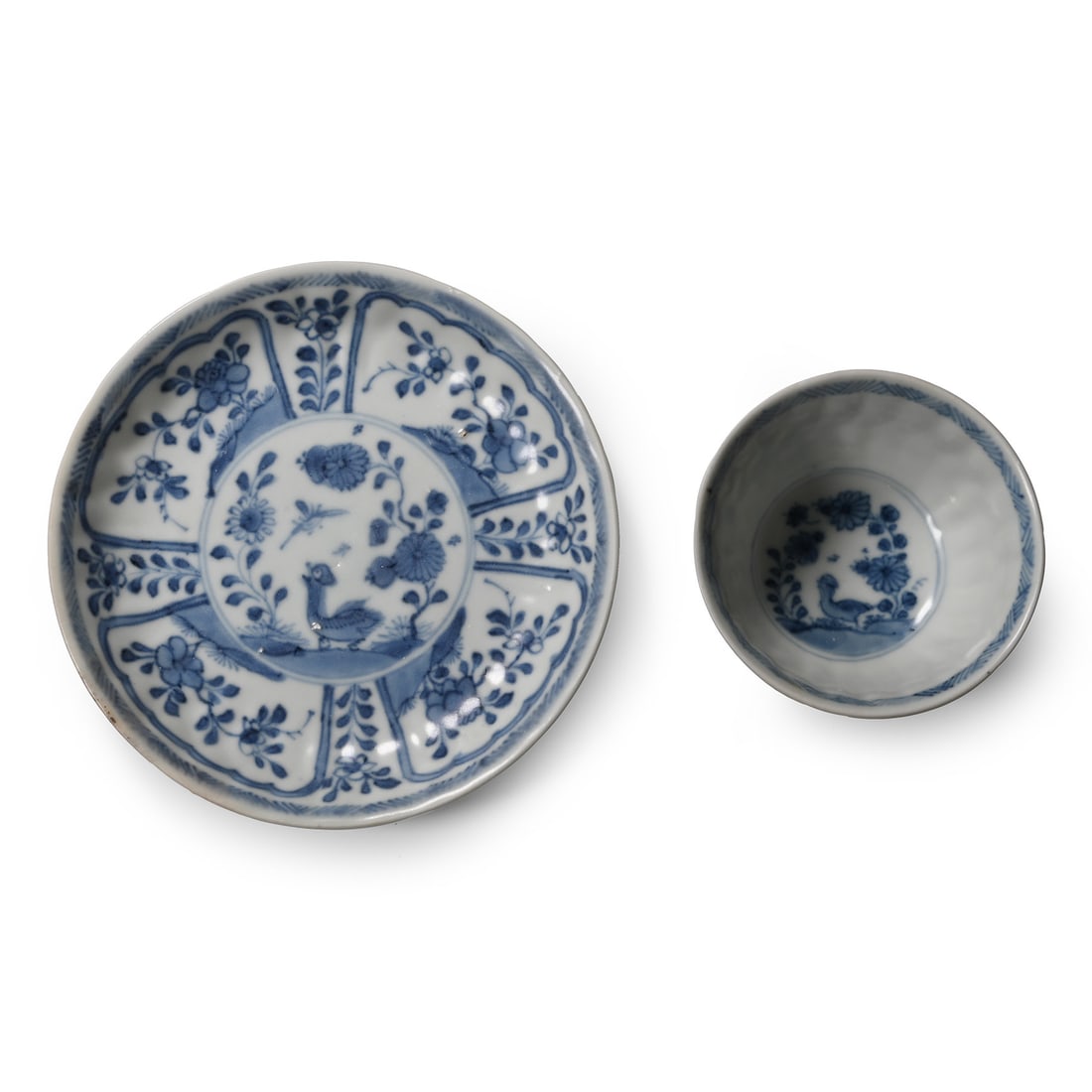 Ca Mau Cargo Shipwreck Glazed Blue and White Tea Cup and Saucer: Early 18th century A.D. Both with a central feature composed of a bird gazing up to a dragonfly, flowers on the field; the saucer with floral panels to the inner face and the cup with similar panels t