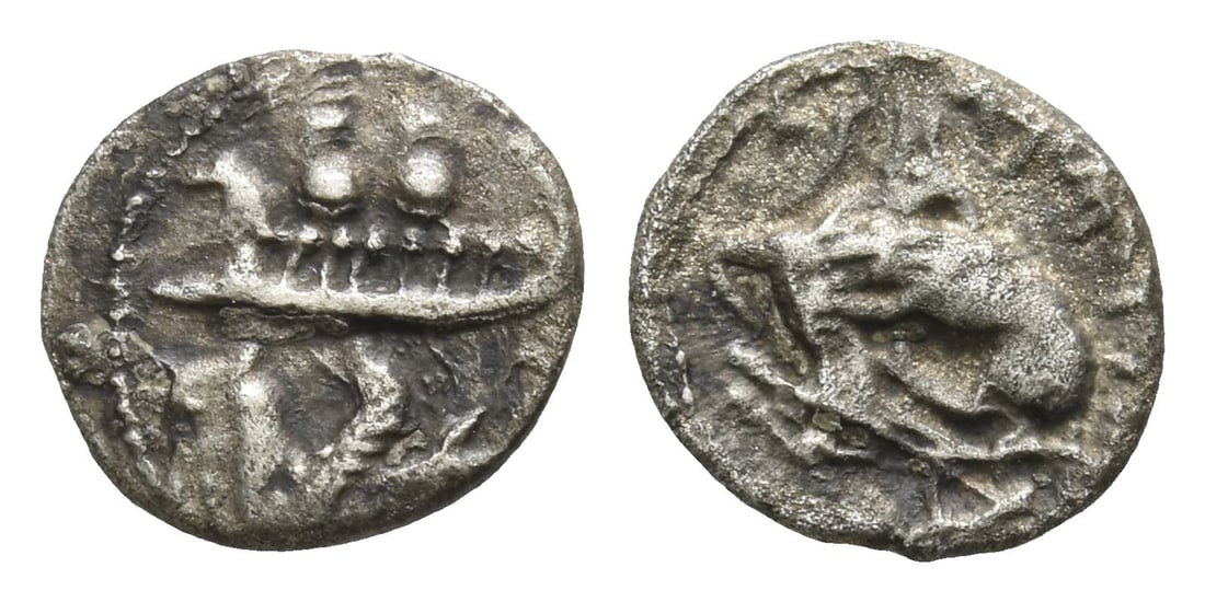 Phoenicia. Byblos, Addirmilk & Iyyenael (?) AR 1/16 Shekel.: Circa 348-332 BC. Two hoplites, holding shields, on galley to left, prow ending in lion's head; below, hippocamp to left / Lion attacking bull to left. Cf. HGC 10, 137. 0.60gr, 9mm, 6h. (For this spec
