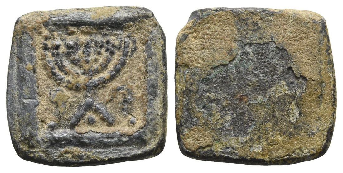 Levante or Egypt Lead Token.: Circa 4th-6th century AD. Seven-branched menorah on triangular base, flanked by lulav(?) on the left and shofar on the right / Blank. 8.93gr, 19mm. Condition as seen. From the collection of a gentlema