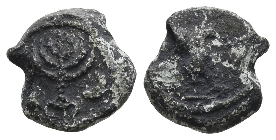 Judaea PB Seal.: 4th-5th century AD. Menorah on tripod base flanked by lulav(?) and shovel(?) to the left and shofar to the right / Falcon or eagle, with spread wings, grasping in talons serpent to right. For similar 
