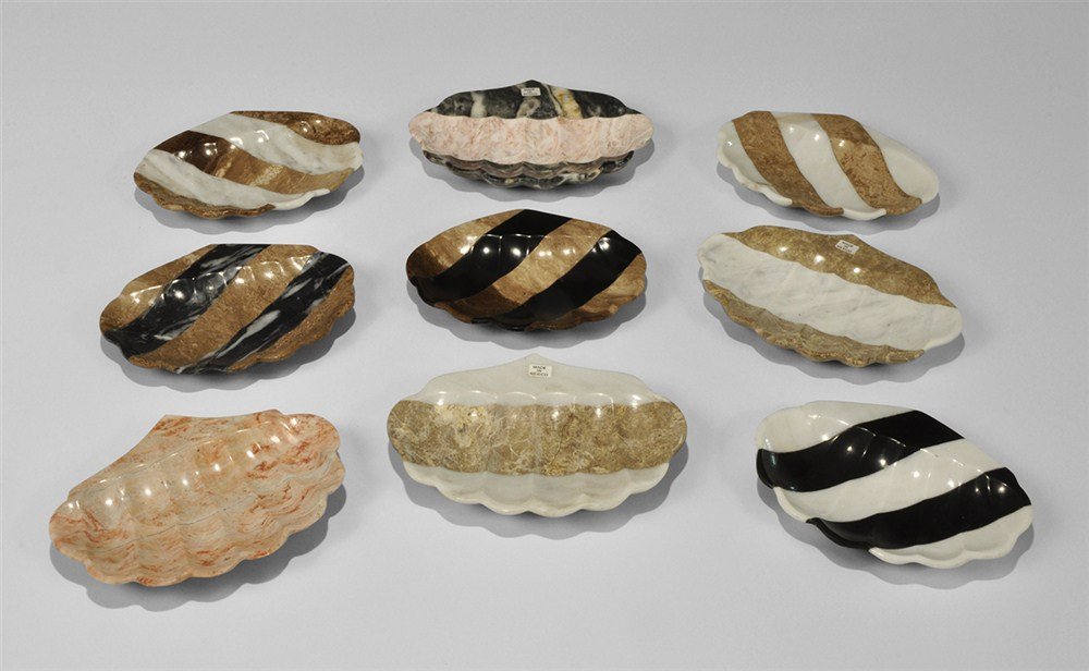 Geological Trade Group: 21 Hand Carved Stone Soap Dishe: A group of 21 semi-precious natural stone, hand-carved soap dishes in the form of a seashell; the lot consisting of 4 dishes carved from solid pink marble with red and white mottling; 1 dish carved fr