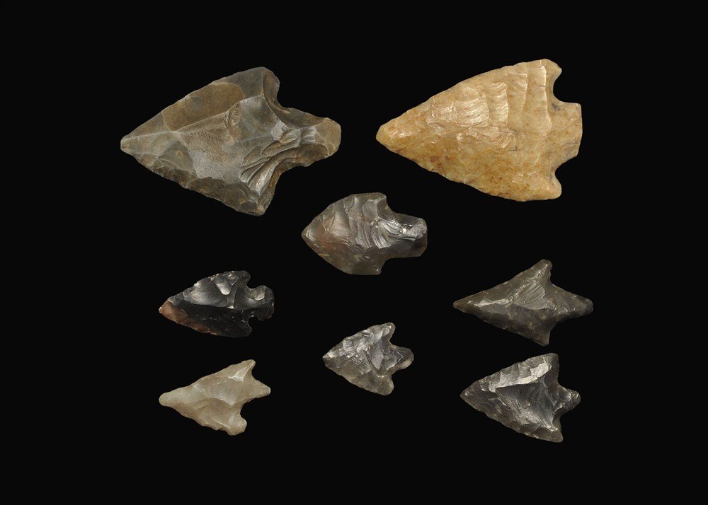 Stone Age Flint Arrowhead Collection: Neolithic to Early Bronze Age, 3000-2000 BC . A group of eight stemmed arrowheads and points comprising: a flint bifacial asymmetric stem type (inked reference 'Ipswich'); a flint bifacial angular typ