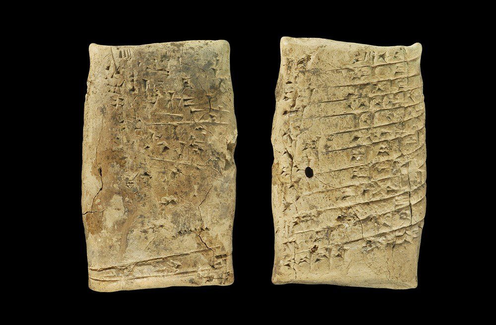 Near Eastern Mesopotamian Ceramic Cuneiform 'Practice L: 1900-1700 BC . An elliptical-section clay tablet with cuneiform text to one face and practice graphemes to the reverse; the text translated as: Speak to Mazanum, Thus says Sin-abi, 'May Shamash [the s