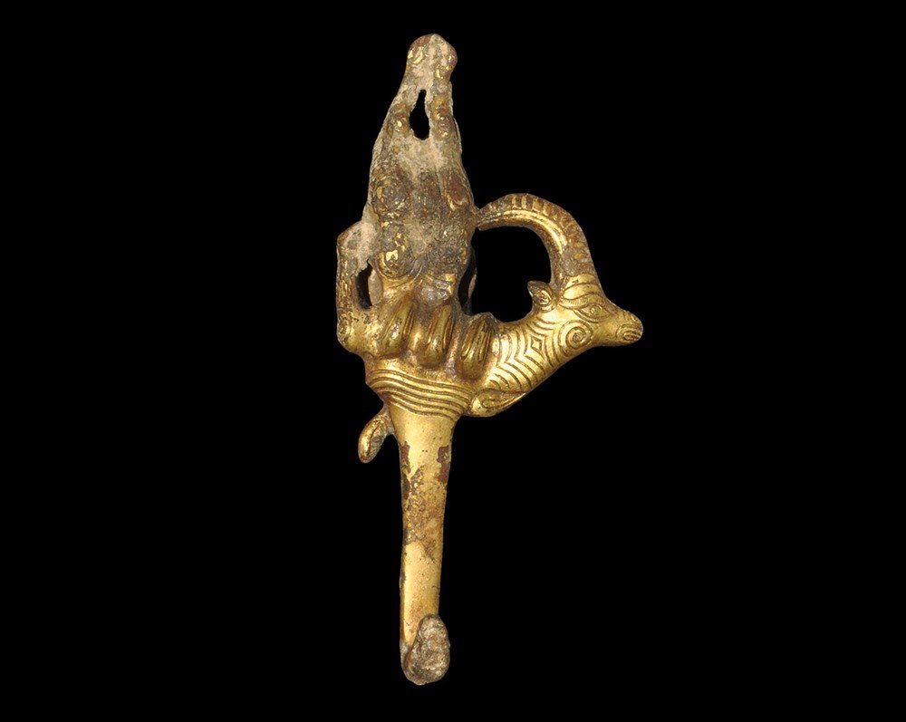 Chinese Gilt-Bronze Belt Hook: Han Dynasty, 206 BC-220 AD or later . A cast belt hook, the upper formed with an antelope head emerging from a three-lobe panel with legs above; below, a square-section hook; to the reverse, a disc-he