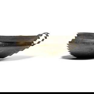 Bronze Age Decorated Bowl with Loop Handle: Circa 1000 B.C. With carinated profile, and flared rim, ancient rivetted repair to central base; strap handle to rear over ancient crack, with evidence of previous repairs. See Claire Copper, et al.,
