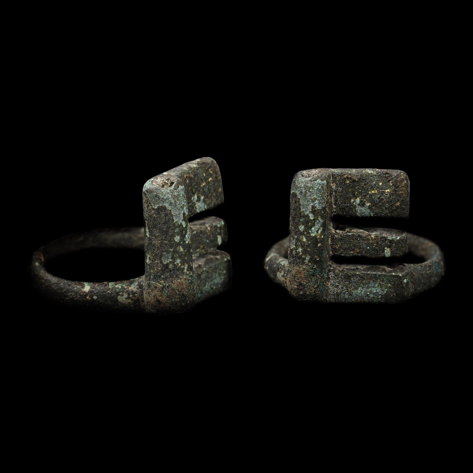 Roman Bronze Key Ring: 1st-4th century A.D. Comprising a narrow hoop, rectangular bezel with flange cut with teeth, tubular frame to rear. Cf. Chadour, A.B., Rings. The Alice and Louis Koch Collection, volume I, Leeds, 1994