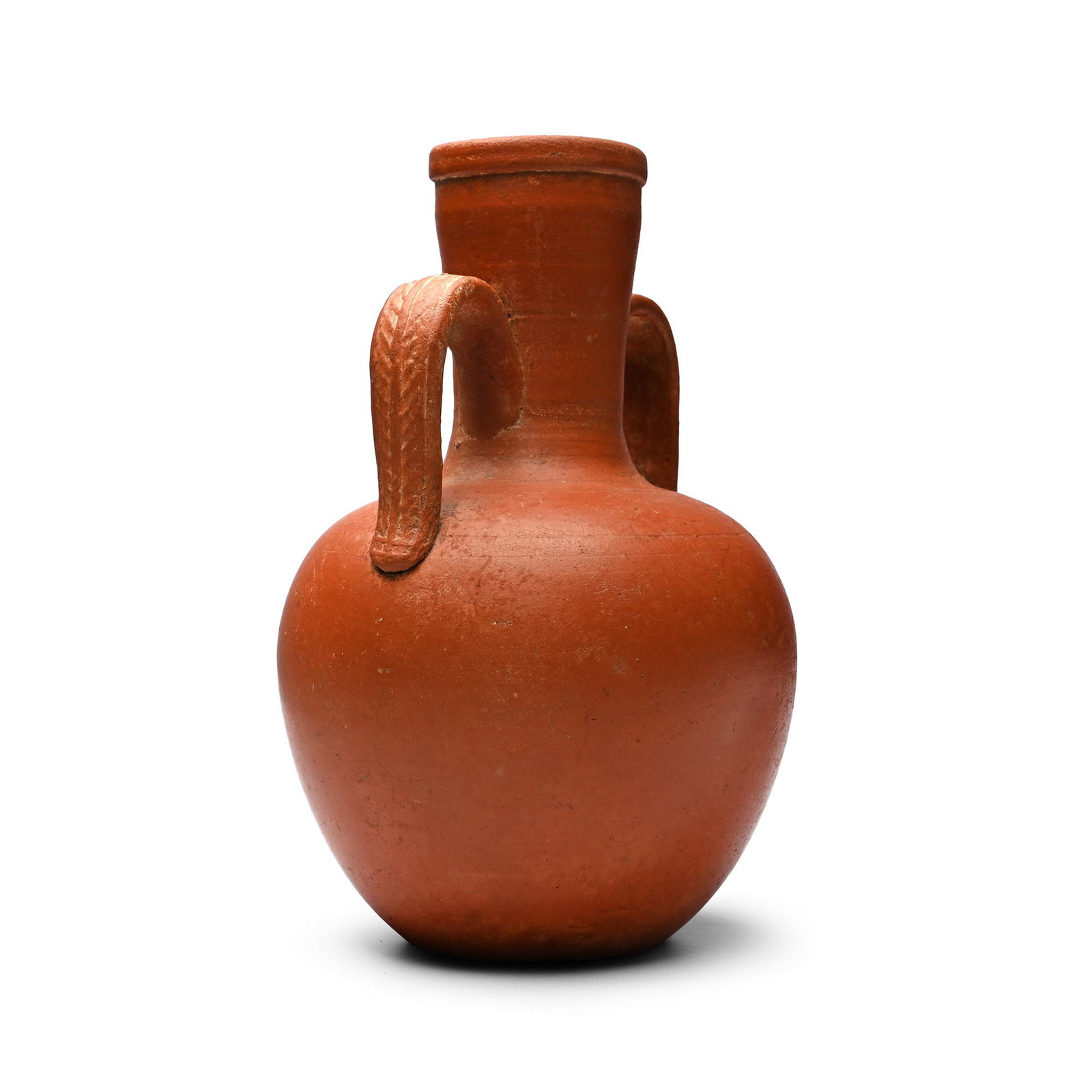 Roman Redware Amphora-Shaped Vase with Leaf-Decorated Handles: 3rd-4th century A.D. Squat in profile with flared neck and ribbed mouth, lateral strap handles with laurel leaf ornament. Cf. Perrin, J.R., The Archaeology of York, The Pottery 16/4, Roman Pottery fro