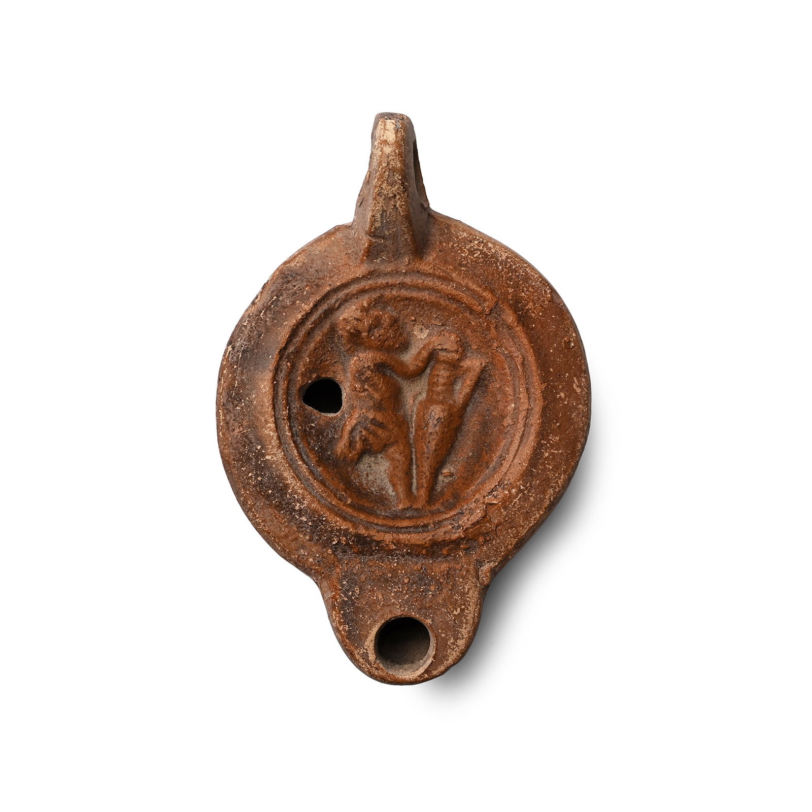 Roman Terracotta Oil Lamp with Slave Holding an Amphora: 2nd century A.D. Discoid in plan with broad D-shaped nozzle, loop handle, discus with low-relief image of a servus wearing a kilt supporting an amphora; maker's mark to underside '[..]VST'. Cf. Bussi�