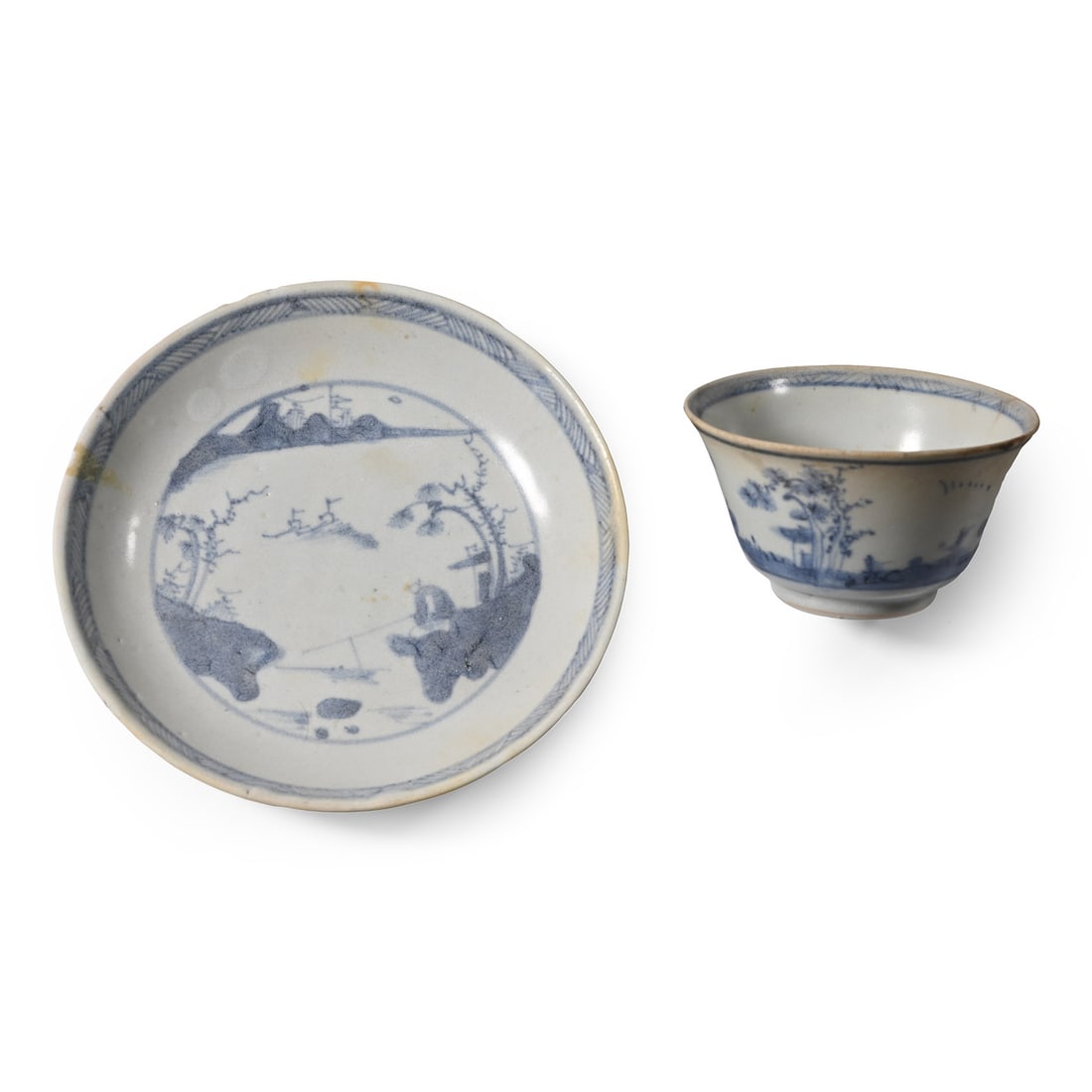 Ca Mau Cargo Shipwreck Glazed Blue and White Tea Cup and Saucer with Fisherman Scene: Early 18th century A.D. Each with a painted lakeside landscape showing a man fishing, mountains and boats floating in the distance. 83 grams total, 6.5-10.6 cm (2 1/2 - 4 1/8 in.). [2, No Reserve] Ex
