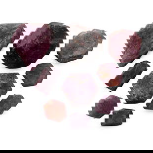 Ruby Crystal Gemstone Group: Comprising six hexagonal crystals, one showing triangular growth marks on both sides of the tabular crystal, one elongated crystal, one rectangular-section cut crystal, accompanied by a large garnet c