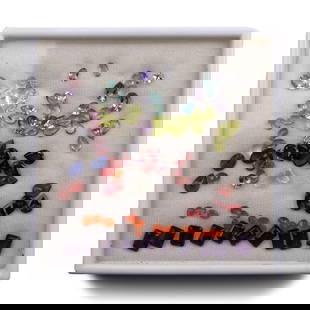 Mixed Cut Gemstone Collection: A collection of translucent facetted gemstones in different cuts and sizes, including amethyst, lapis lazuli, garnet, aquamarine and peridot; contained in a display case. 89 grams total, 90 x 90 mm in