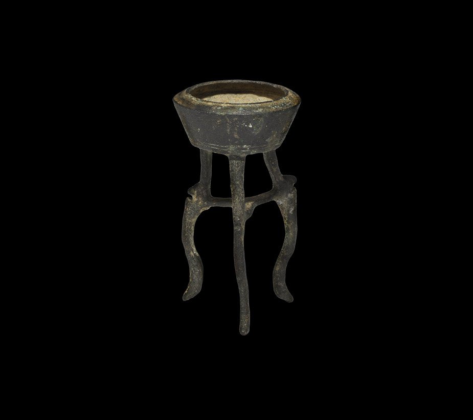 Byzantine Bronze Votive Incense Burner: 5th-9th century AD. A cast bronze incense burner with carinated bowl and three recurved legs with animal-head detail. Property of a London collector, acquired before 1980. 29 grams, 64 mm (2 1/2").
