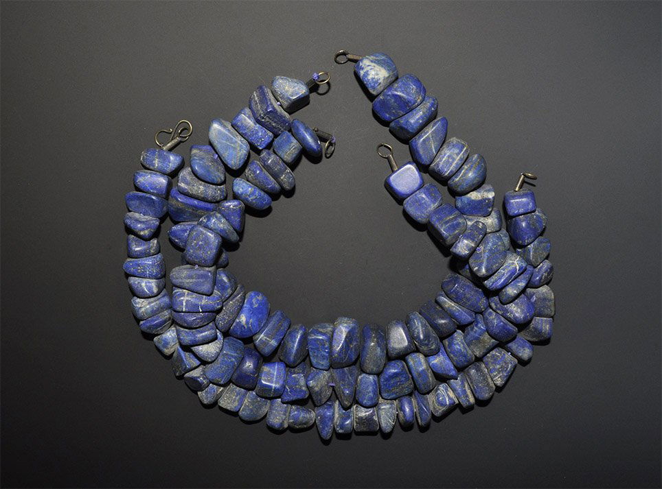 Near Eastern Style Lapis Lazuli Necklace Bead String Gr: A mixed group of restrung undated archaistic three choker-length strands of irregularly-shaped lapis chunks of good blue colour, needing clasps. Property of a London Gentleman. 911 grams total, 43-44