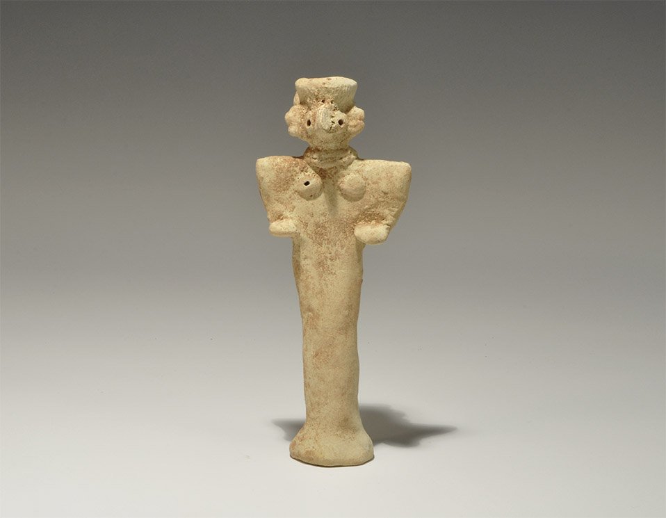 Near Eastern Syro-Hittite Ceramic Fertility Figure: Syro-Hittite States, 1180-700 BC. A creamware figurine depicting a female with arms raised to the chest; the eyes and breasts formed with round recesses, the necklace separately applied; the legs comb