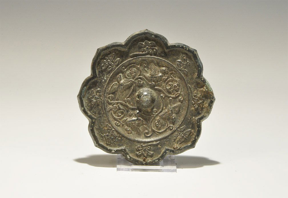Chinese Style Bronze Figural Mirror with Birds, Insects: An undated archaistic discoid rosette bronze mirror with one tinned surface, the reverse with central pierced lug surrounded by a frieze of birds and tendrils, with insects and flowers to the border.