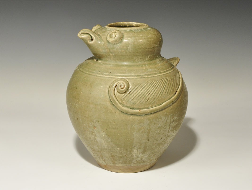 Cambodian Style Ceramic Bird Urn: An undated archaistic green-glazed ceramic urn with applied wings, tails and facial details. Property of a London collector, acquired early 1960s. 1.4 kg, 21 cm (8 1/4"). [No Reserve]