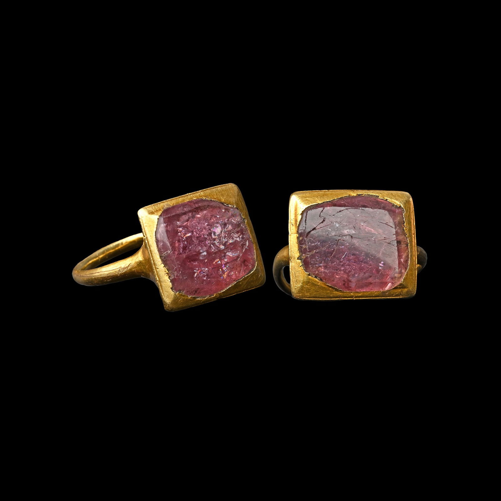 Spanish Gold Ring with a Table-Cut Red Spinel: 16th-17th century A.D. A substantial ring with a box-shaped bezel set with a table-cut red spinel of deep purplish-red hue, the reverse of the bezel convex with chamfered ends. 6.93 grams, 24.30 mm ov
