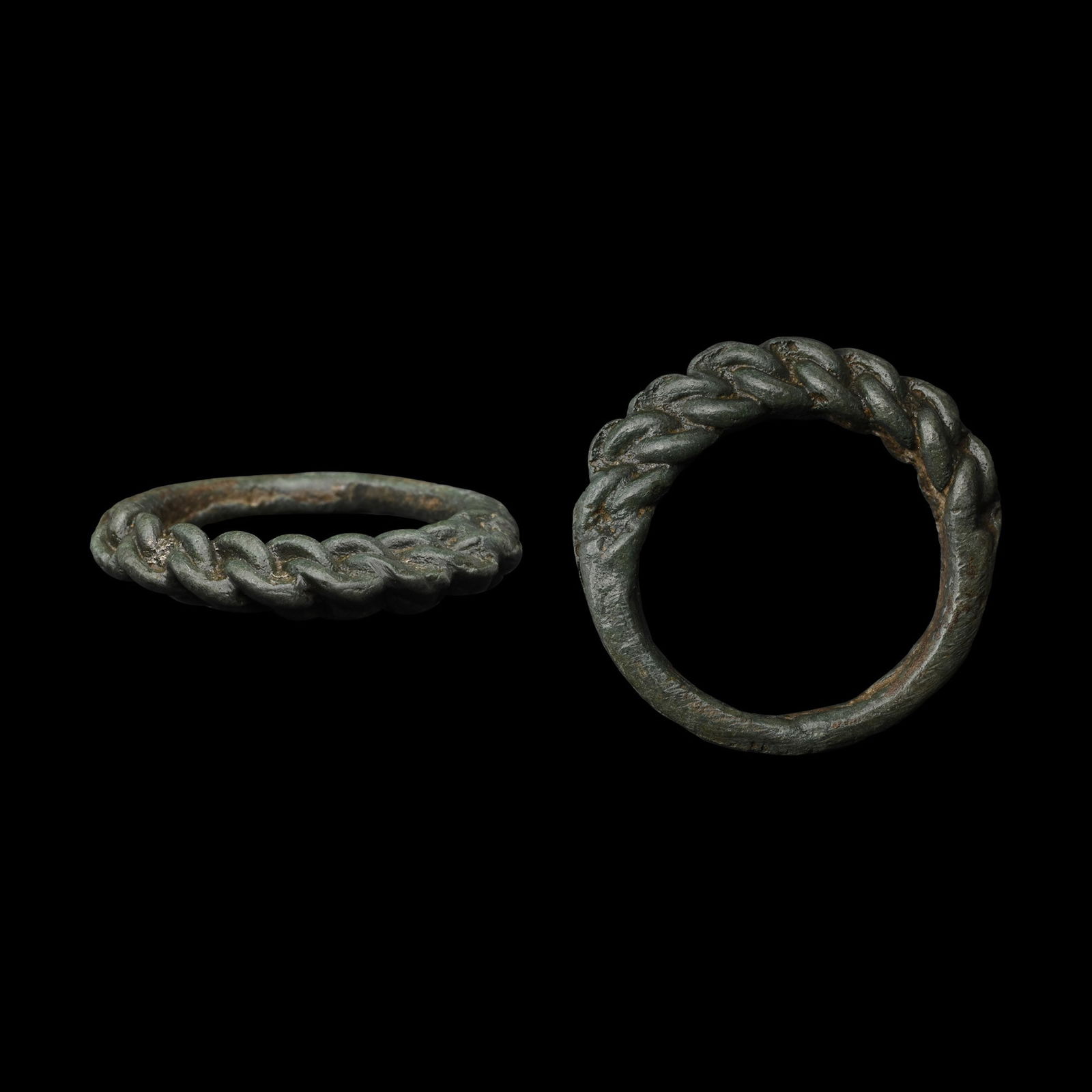 Viking Bronze Pseudo Interlaced Ring: 9th-11th century A.D. Comprising a braided band of wire, butted on the underside. Cf. Sedov, B.B., Finno-Ugri i Balti v Epokhi Srednevekovija, Moscow, 1987, pl.CXXXVII (15). 4.84 grams, 26.80 mm overa