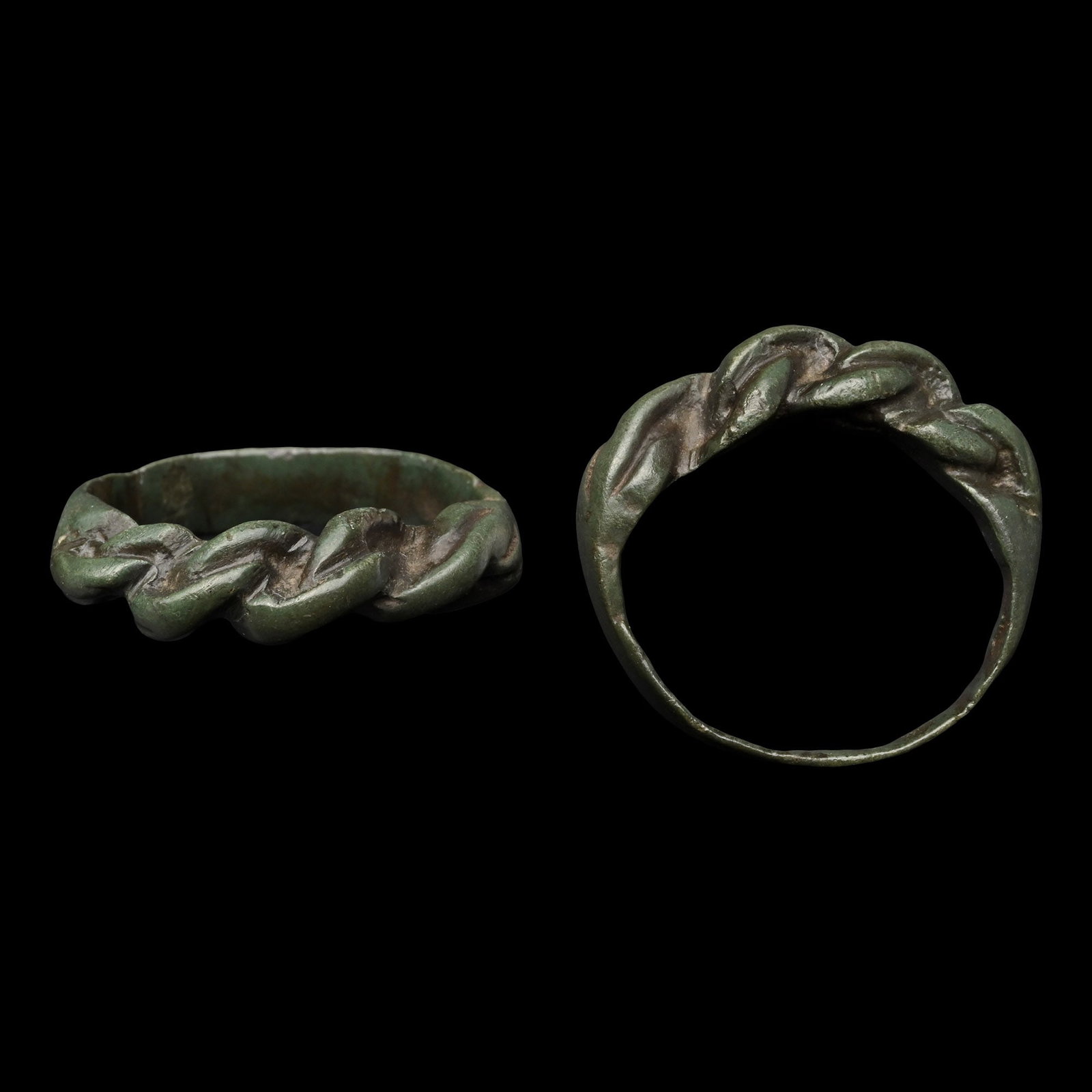 Viking Bronze Pseudo Interlaced Ring: 9th-11th century A.D. With thick braided bezel of three wires, flat butted reverse. Cf. Sedov, B.B., Finno-Ugri i Balti v Epokhi Srednevekovija, Moscow, 1987, pl.CXXXVII, item 14, for type. 4.70 grams