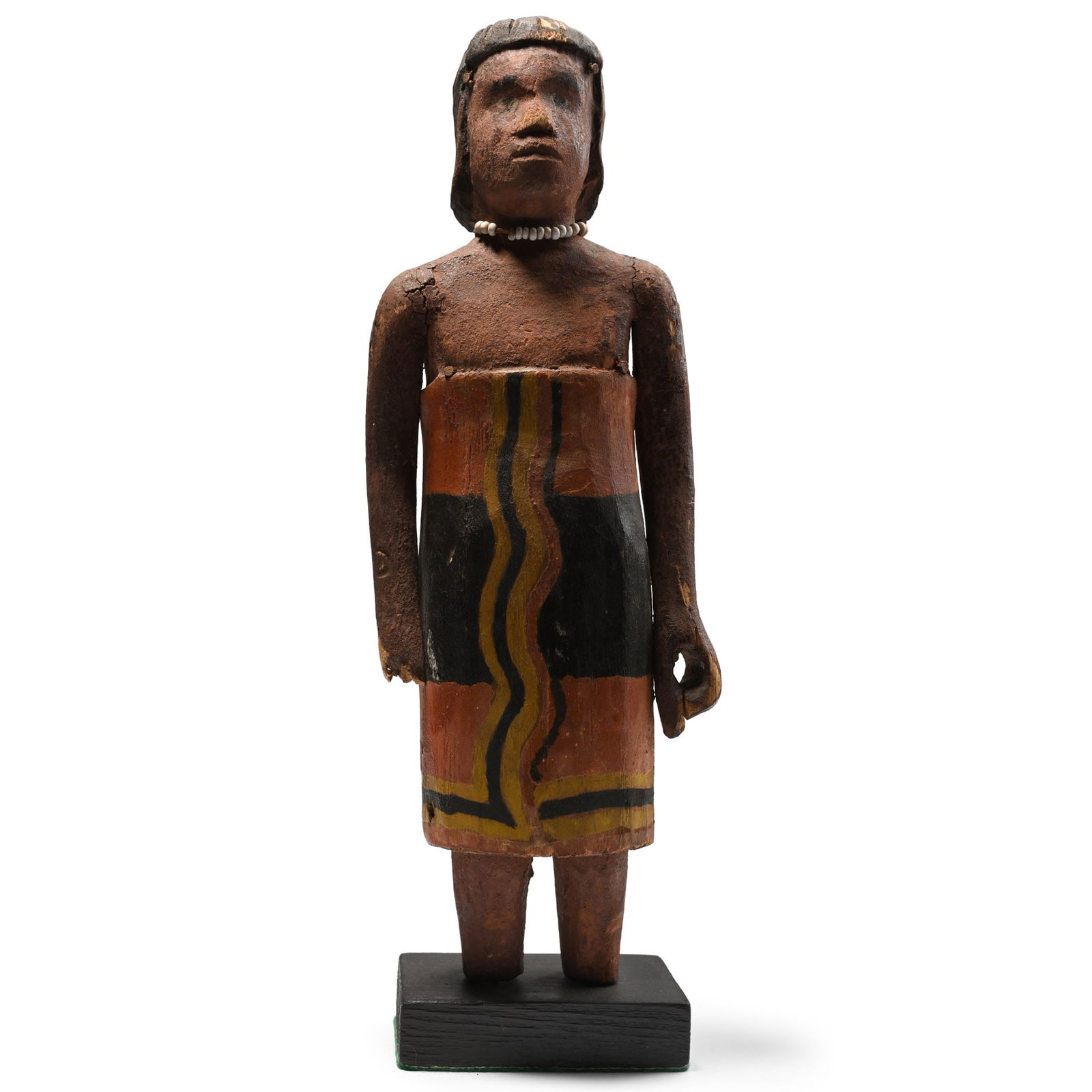 African Wooden Ceremonial Figure: Madagascan Tribe, 20th century A.D. A painted female figure in knee-length robe with a white glass bead necklace, mounted on a later black wooden display base. 157 grams, 28 cm (11 in.). [No Reserve]