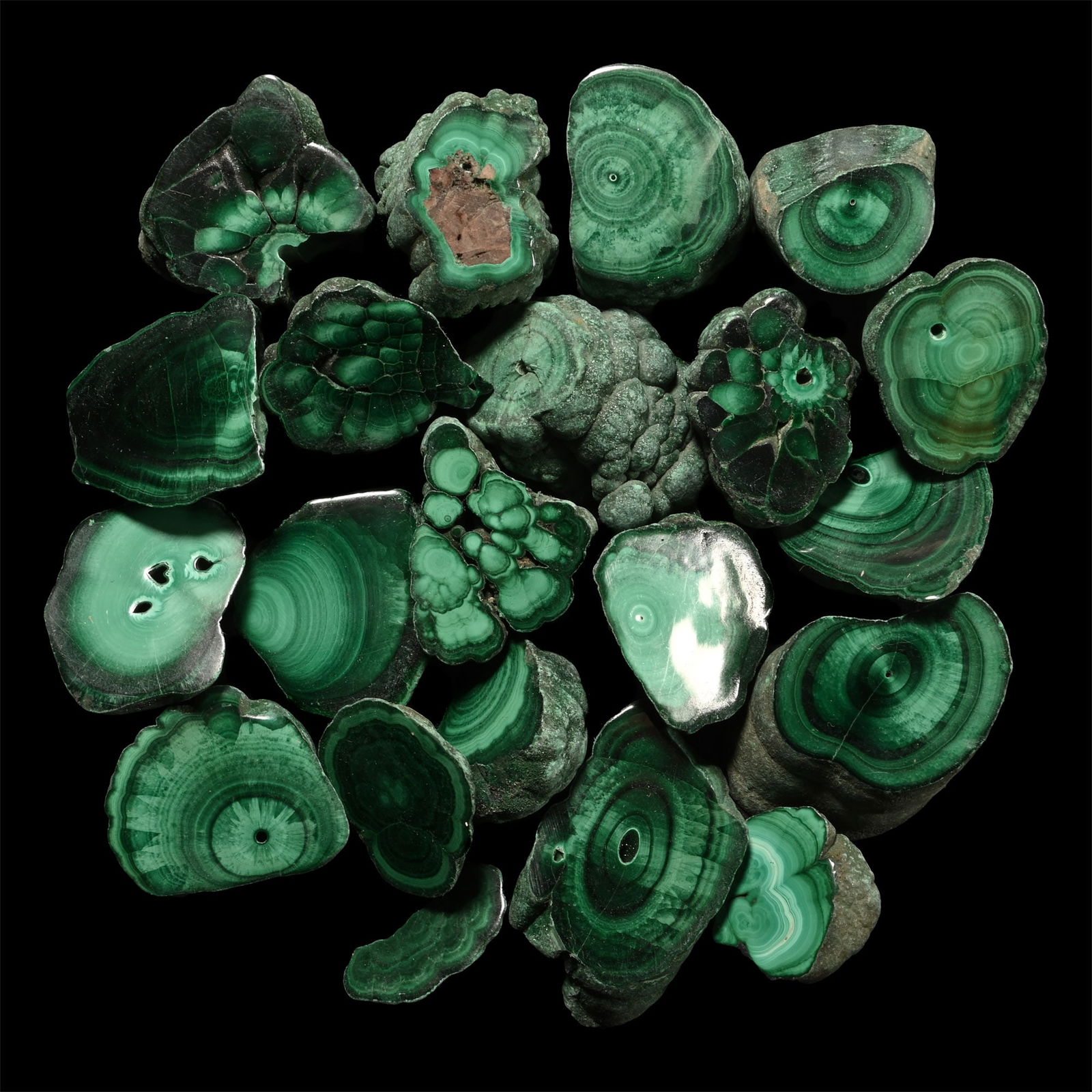 Cut and Polished Green Malachite Mineral Specimen Group [20]: Comprising twenty specimens with polished faces displaying attractive banding and 'eye' formations, some pierced, one with a small heart-shaped opening. 210 grams total, 19-38 mm (3/4 - 1 1/2 in.). [2