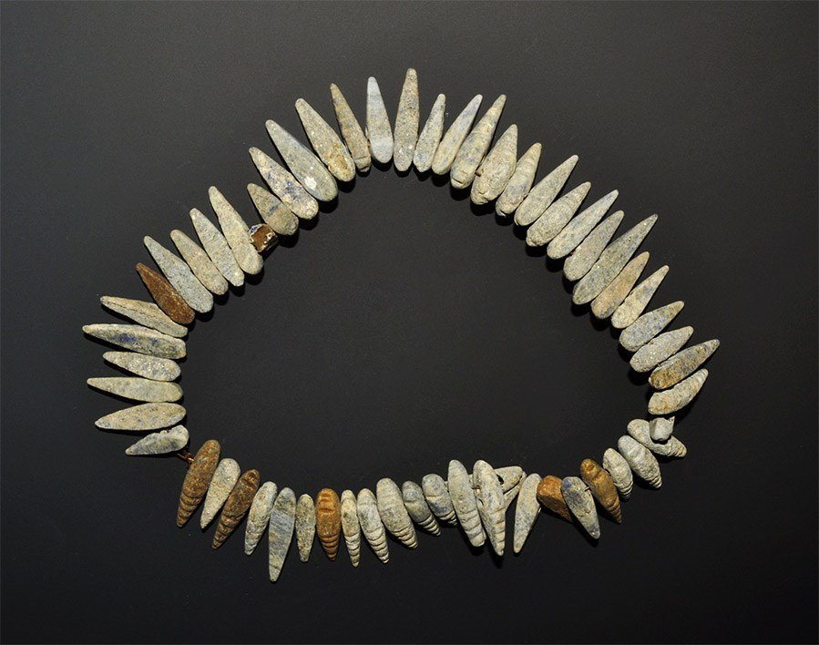 Afghan Lapis Lazuli Beads: A short strand of carved lapis insect grub shapes drilled across one end, encrusted with grey and brown mineral deposits, for restringing. Acquired on the London art market in the 1960s. 86 grams, 30 