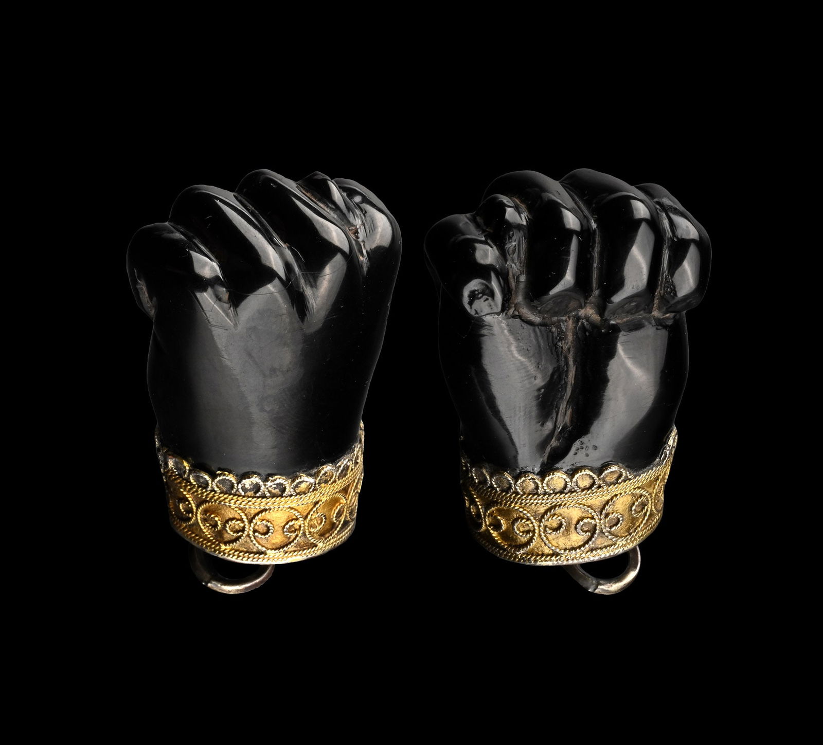 Silver-Gilt Mounted Jet 'Figa' Amulet: Spain, 17th century A.D. Formed as a hand showing figa gesture, silver mount with applied twisted wires; attachment loop and ring to the top. 19.6 grams, 56 mm (2 1/4 in.). Private collection, Europe.