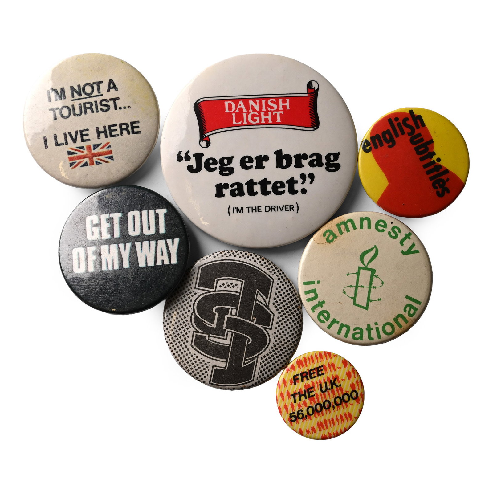 Miscellaneous Vintage Pin Badge Collection: Circa 1980s A.D. Including 'Amnesty International', 'I'm Not a Tourist . I Live Here' and other types. 33 grams total, 24-56 mm (1 - 2 1/4 in.). [7, No Reserve] From the private collection of a