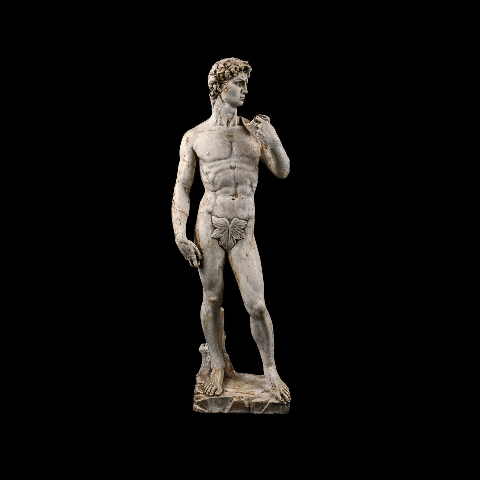 Replica of David Statue by Michelangelo: Late 19th-20th century A.D. A composition statue modelled after the Italian Renaissance masterpiece sculpted by Michelangelo, David depicted nude in a contrapposto position, carrying the weight on his