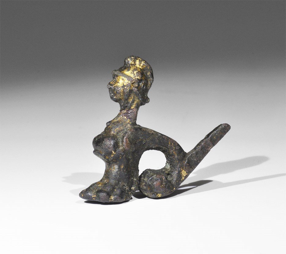 Roman Gilt Bronze Minerva Casket Leg: 1st-3rd century AD. A cast casket foot formed as the helmetted head of Minerva above a lion's claw with scrolled bar to the rear and spike above. 20 grams, 37 mm (1 1/2"). Found Lincolnshire, UK, in 2