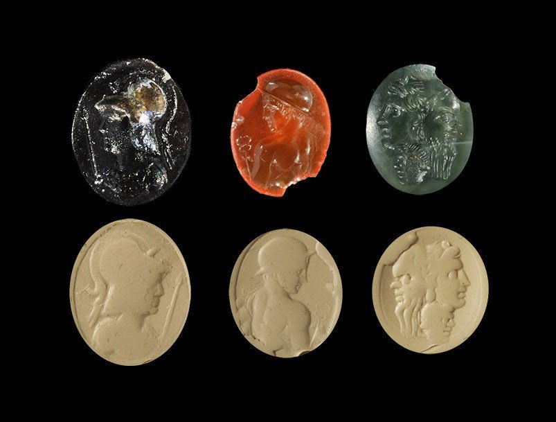 Roman Gemstone Intaglio Group: 1st-3rd century AD. A mixed group of elliptical intaglio seal matrices comprising: bust of Hermes in petasos with caduceus; bust of Minerva in helmet with spear; bust of Janus. 1.78 grams total, 11-16