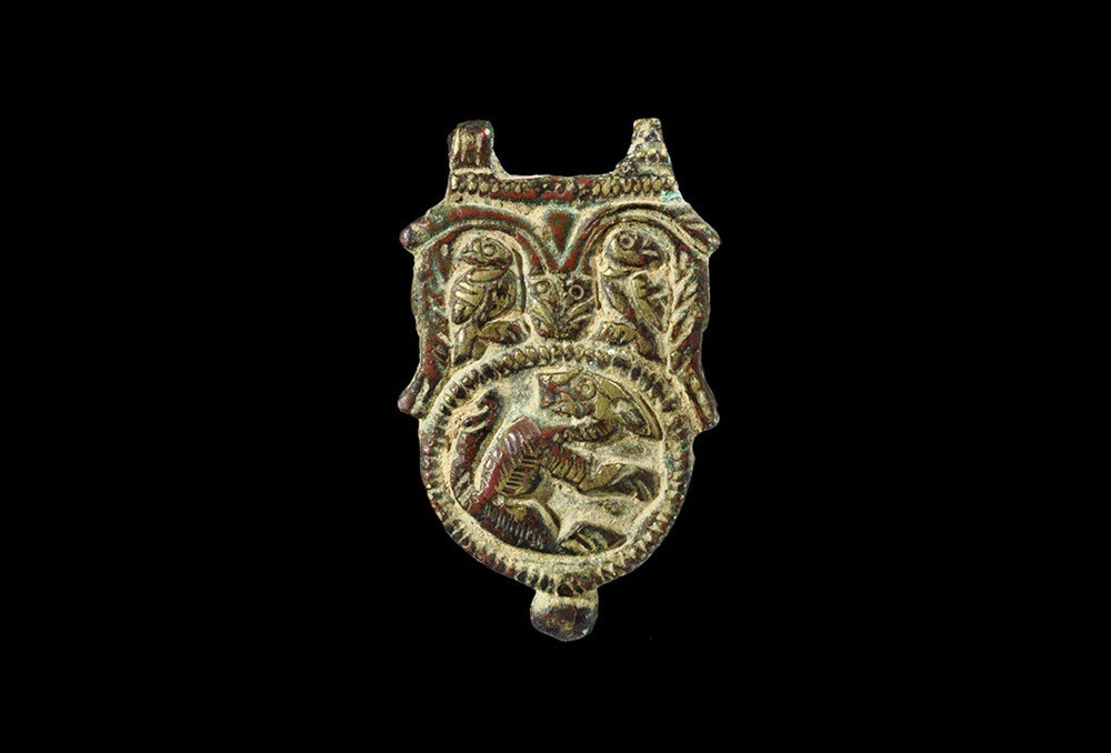 Byzantine Bronze Zoomorphic Buckle Plate: 6th-9th century AD. A cast buckle plate with hinge lugs to the forward edge, two pierced lugs to the underside; the plate with a large ropework circle with regardant beast within and two D-shaped pane