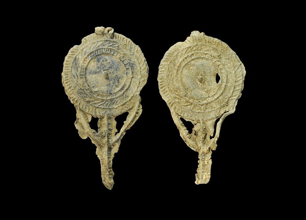 Byzantine Lead Mirror Group: 7th-10th century AD. A group of two cast hand-held mirrors with concentric circles and hatching to the reverse. 90 grams total, 98-103 mm (3 3/4"). Private collection formed in the 1990s. [2, No Reser