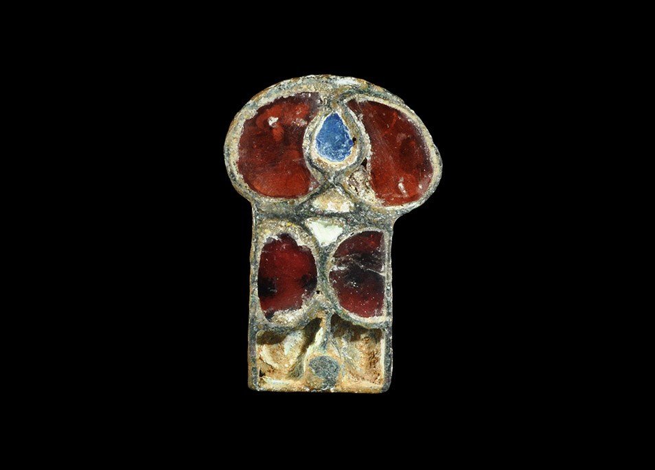 Merovingian Bronze Garnet-Inlaid Belt Plate: 6th-7th century AD. A plaque with discoid and rectangular elements, two c-shaped garnets and a piriform blue glass centre above two opposed D-shaped garnet panels with flanking cells (contents absent)
